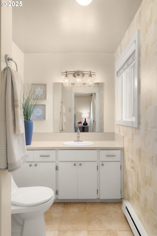 1615 Kingwood St, Forest Grove, OR 97116 - bathroom featuring a baseboard heating unit, vanity, toilet, and wallpapered walls