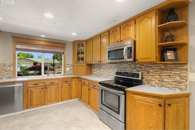 1615 Kingwood St, Forest Grove, OR 97116 - kitchen featuring appliances with stainless steel finishes, light countertops, a sink, recessed lighting, and tasteful backsplash