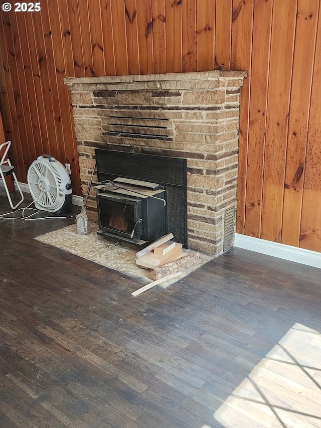 544 Lou Gray Dr, Myrtle Creek, OR 97457 - detailed view of wood finished floors, wooden walls, and a wood stove