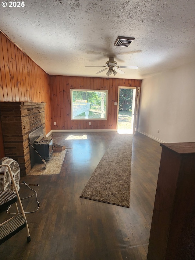 544 Lou Gray Dr, Myrtle Creek, OR 97457 - unfurnished living room with healthy amount of natural light, wood finished floors, a textured ceiling, ceiling fan, and wood walls