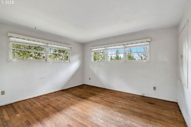 empty room with hardwood / wood-style floors