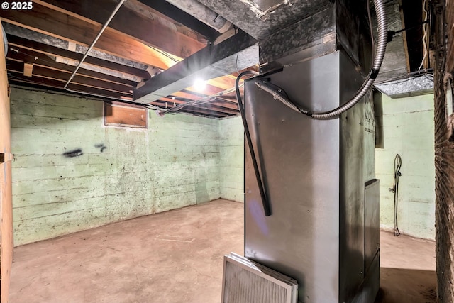 unfinished basement featuring heating unit