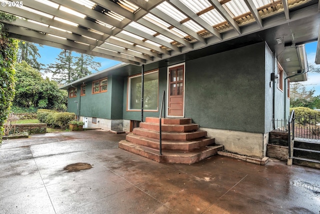 exterior space with entry steps and stucco siding