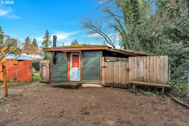 view of shed featuring fence