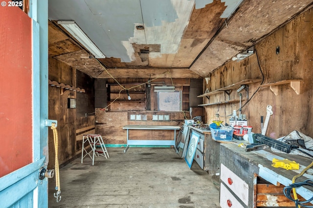 misc room featuring wooden walls