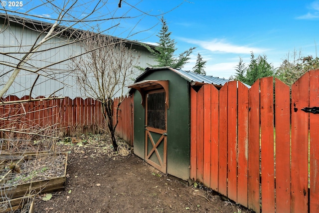 view of outbuilding featuring fence and an outdoor structure