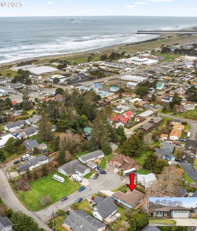 bird's eye view featuring a water view, a residential view, and a view of the beach