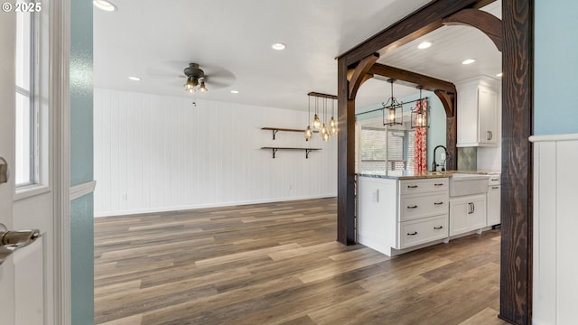 interior space with hanging light fixtures, dark wood-style floors, ceiling fan, and a sink