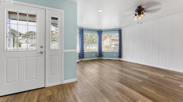 entryway featuring ceiling fan, wood finished floors, and baseboards