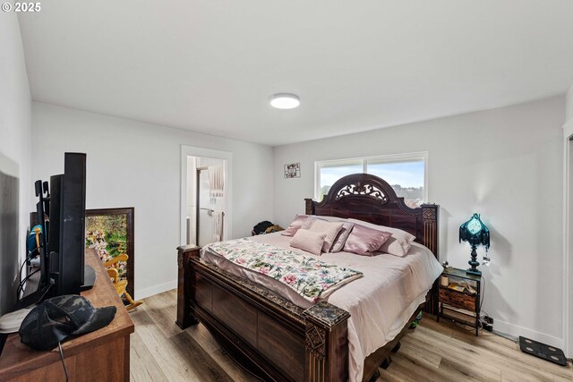 546 W Fir Ave, Coos Bay, OR 97420 - bedroom with light wood-style flooring, connected bathroom, and baseboards