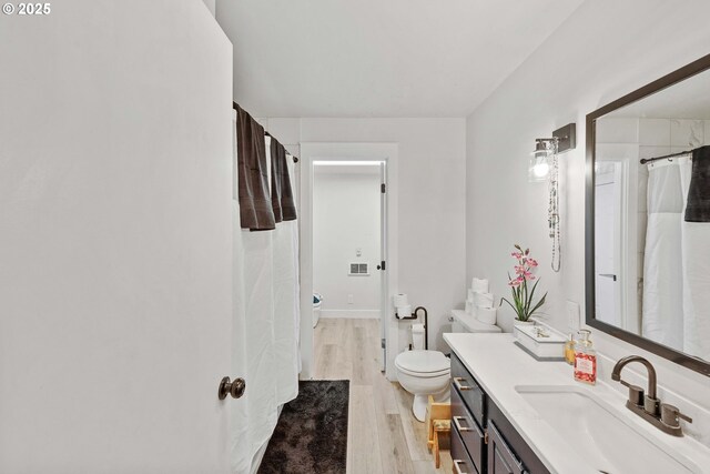 546 W Fir Ave, Coos Bay, OR 97420 - bathroom featuring toilet, wood finished floors, and vanity