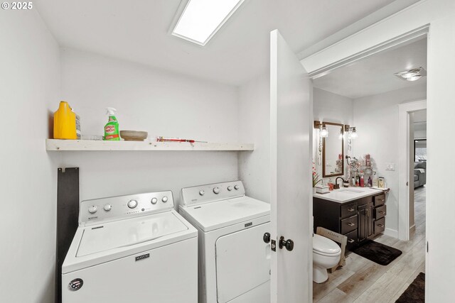 546 W Fir Ave, Coos Bay, OR 97420 - laundry room with washer and dryer, laundry area, light wood finished floors, and a sink