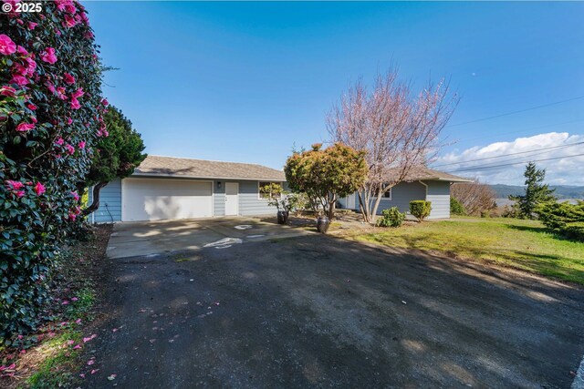 546 W Fir Ave, Coos Bay, OR 97420 - ranch-style home featuring a front lawn and a garage
