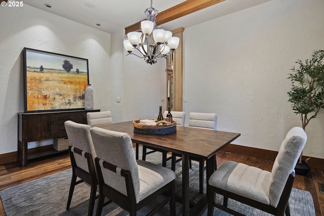 dining area featuring dark hardwood / wood-style flooring and a notable chandelier