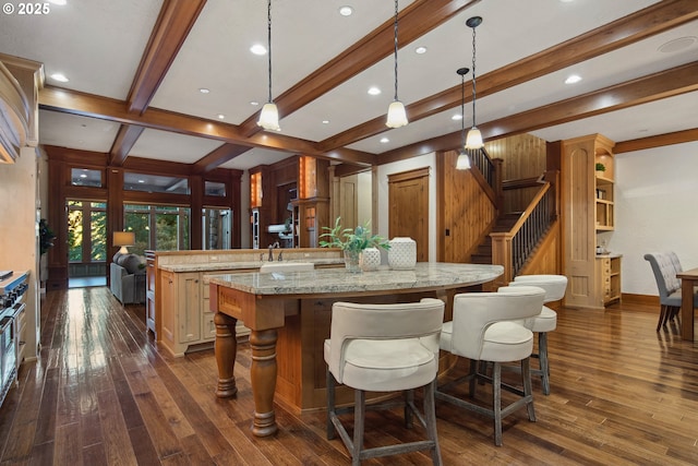 kitchen featuring a breakfast bar area, pendant lighting, dark hardwood / wood-style flooring, and kitchen peninsula