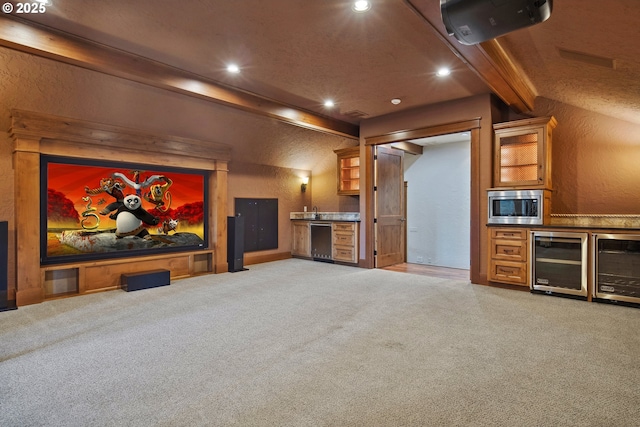 home theater room featuring indoor bar, beverage cooler, and beam ceiling