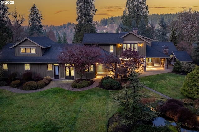 view of front of house with a yard and a patio