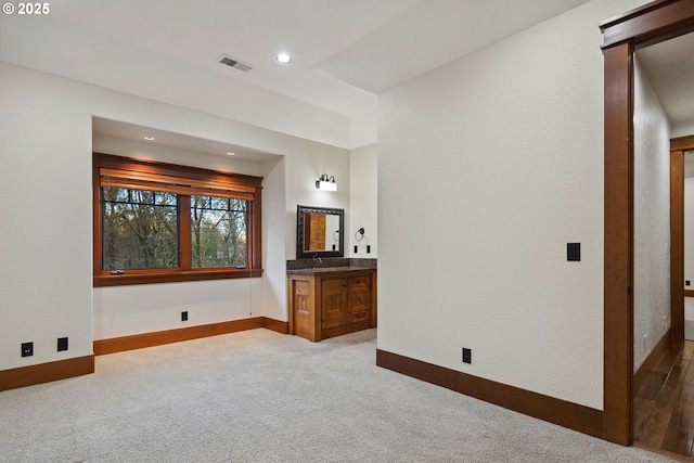 interior space featuring sink and carpet flooring