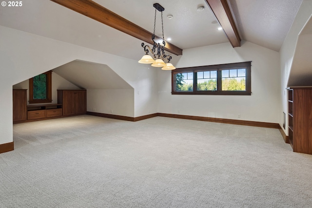 bonus room featuring vaulted ceiling with beams, a chandelier, and carpet flooring