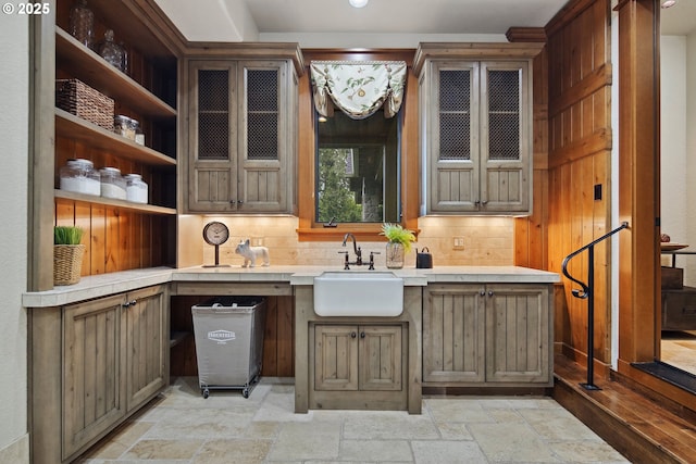 bar featuring tasteful backsplash and sink