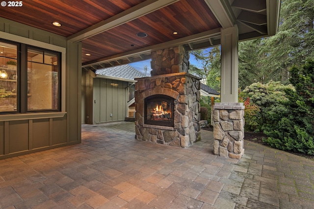 view of patio / terrace featuring an outdoor stone fireplace