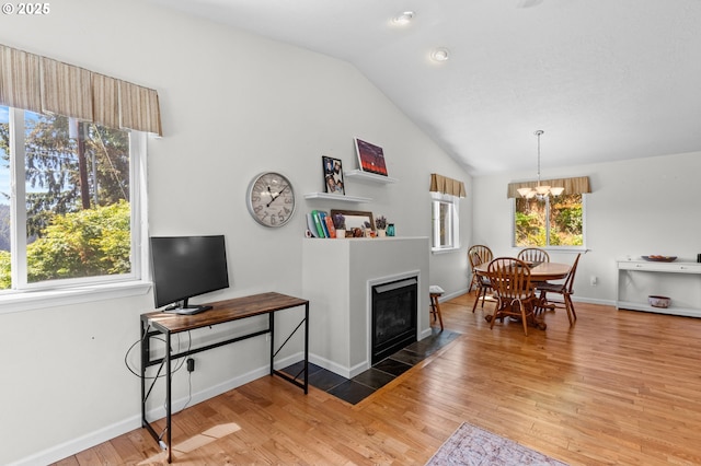 579 S Schooner Creek Rd, Lincoln City, OR 97367 - living room featuring lofted ceiling, light wood-style floors, a fireplace with flush hearth, a chandelier, and baseboards