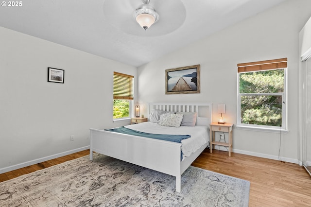 579 S Schooner Creek Rd, Lincoln City, OR 97367 - bedroom with vaulted ceiling, wood finished floors, baseboards, and a ceiling fan