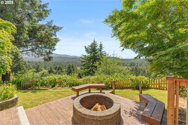 579 S Schooner Creek Rd, Lincoln City, OR 97367 - wooden terrace with a fire pit, a mountain view, and a view of trees