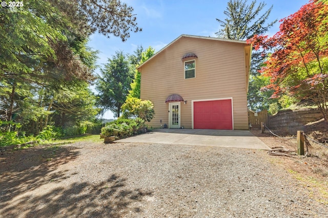 579 S Schooner Creek Rd, Lincoln City, OR 97367 - view of front of house featuring dirt driveway and an attached garage