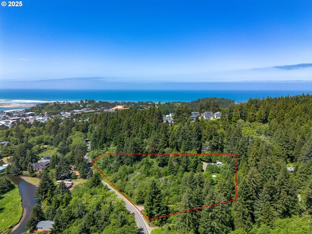 579 S Schooner Creek Rd, Lincoln City, OR 97367 - view of property location featuring a heavily wooded area, property boundaries highlighted, and a large body of water