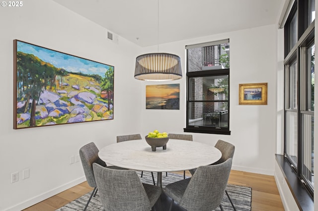 dining space with light wood-type flooring