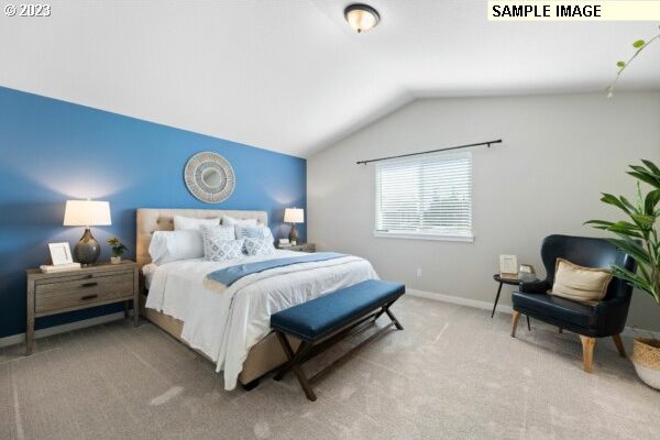 bedroom with carpet and lofted ceiling