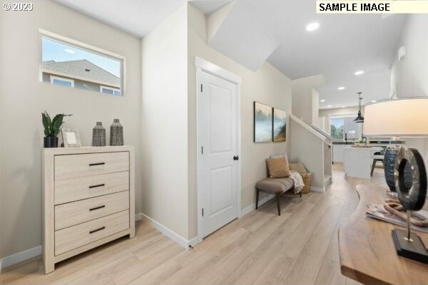 hall with light hardwood / wood-style floors