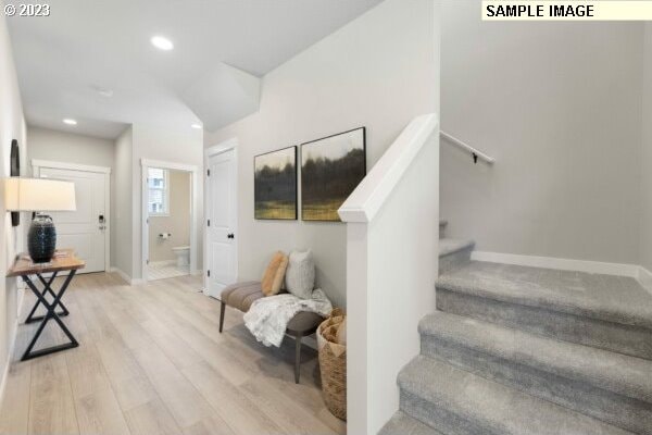 staircase with hardwood / wood-style flooring