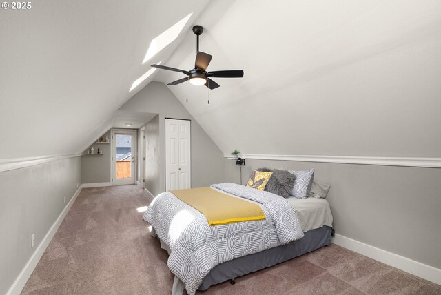 bedroom featuring carpet flooring, baseboards, vaulted ceiling, a closet, and ceiling fan