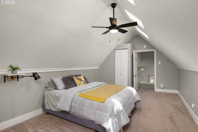 bedroom featuring carpet flooring, a skylight, a closet, lofted ceiling, and baseboards