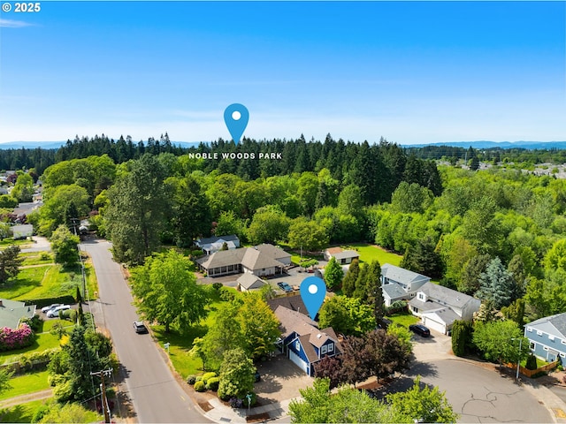 aerial view of residential area featuring a heavily wooded area