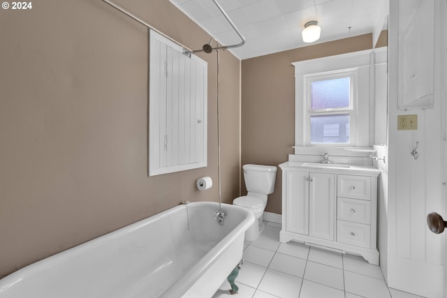 full bathroom with vanity, a freestanding bath, tile patterned flooring, and toilet