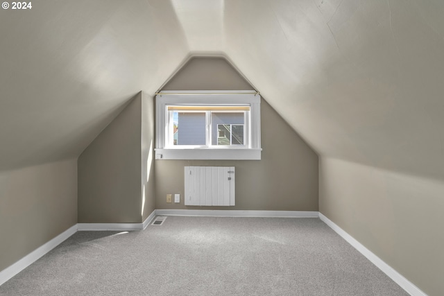 bonus room with visible vents, radiator, baseboards, carpet, and lofted ceiling