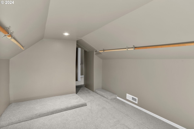 additional living space with visible vents, baseboards, vaulted ceiling, carpet flooring, and recessed lighting