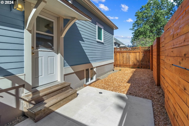 doorway to property with a patio area and fence