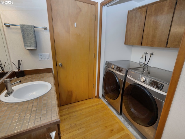 7705 S Fulton Park Pl, Portland, OR 97219 - clothes washing area featuring washer and clothes dryer and light wood finished floors