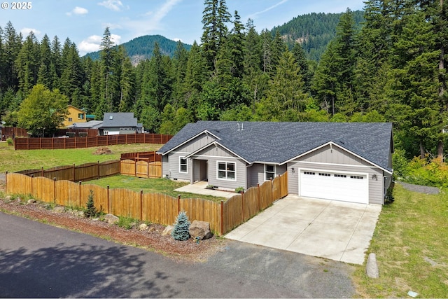 202 Edgewater Dr, Carson, WA 98610 - view of front of home featuring board and batten siding, a forest view, an attached garage, and driveway