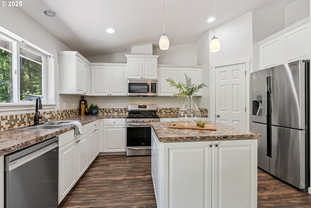 202 Edgewater Dr, Carson, WA 98610 - kitchen with stainless steel appliances, vaulted ceiling, a center island, white cabinets, and dark wood-style flooring