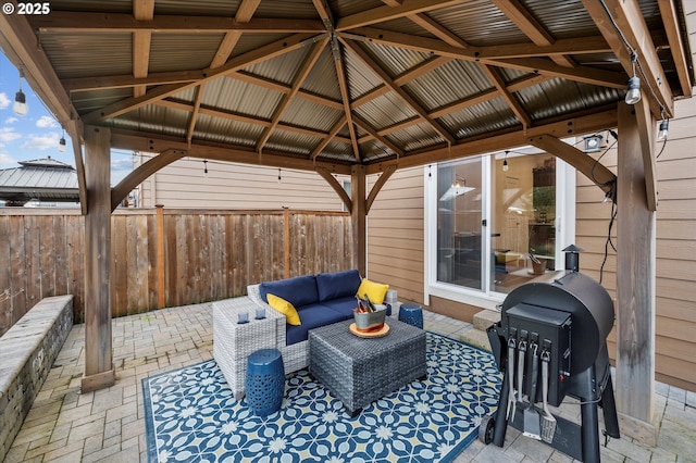 view of patio with an outdoor living space, a gazebo, and a grill