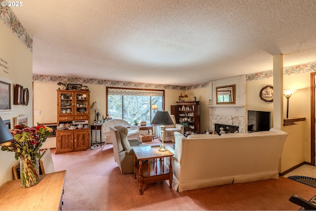 carpeted living room with a fireplace, baseboards, and a textured ceiling