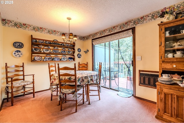 dining area featuring an inviting chandelier, carpet, baseboards, and a textured ceiling