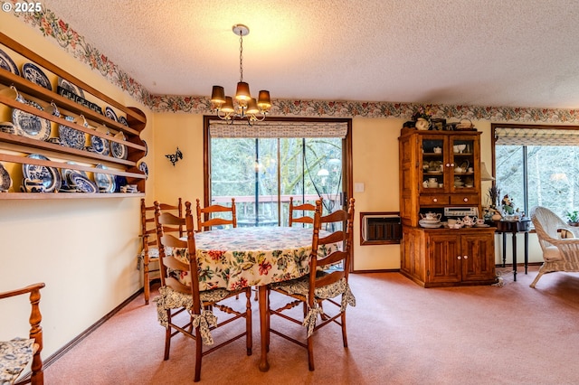 dining room with plenty of natural light, carpet, a textured ceiling, and an inviting chandelier