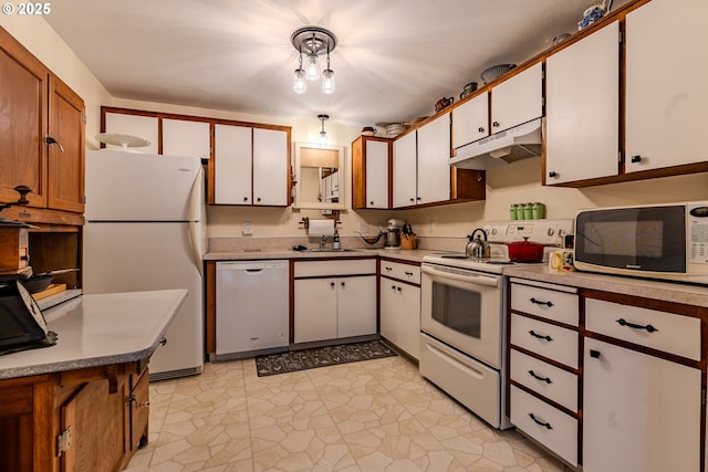 kitchen featuring white appliances, under cabinet range hood, white cabinets, and light countertops