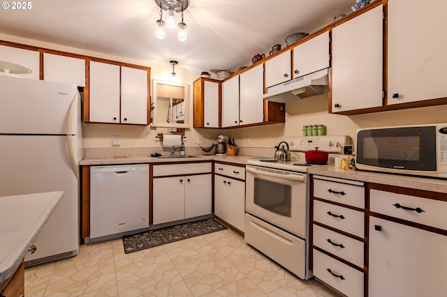 kitchen featuring under cabinet range hood, white appliances, light countertops, and white cabinets